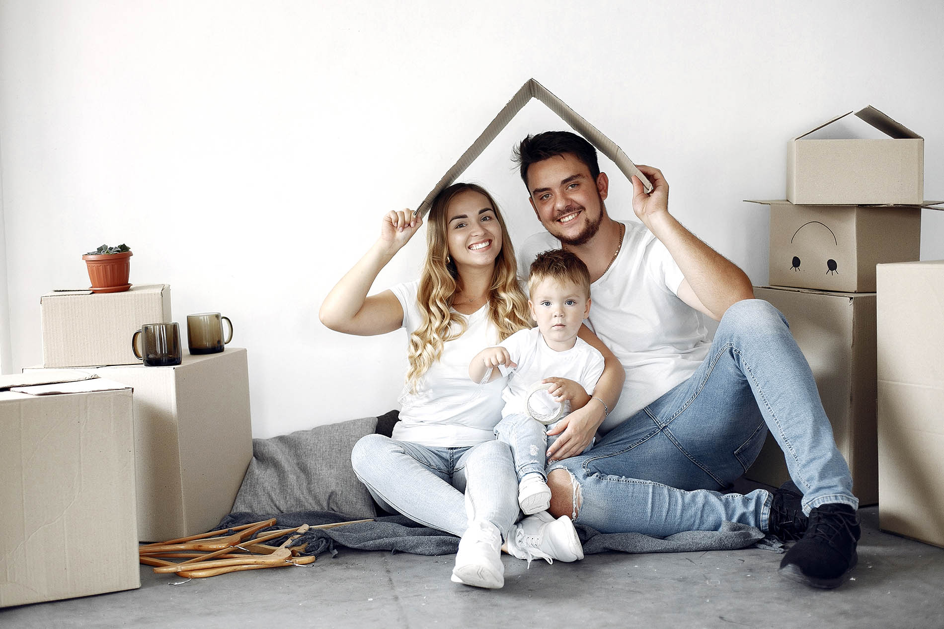 Family sitting together, ready to move into their new home